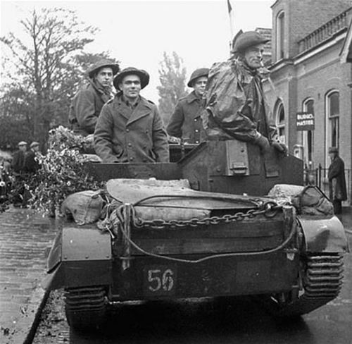 Personnel of the Royal Hamilton Light Infantry riding in Universal Carrier 27 Oct. 1944 / Krabbendijke, Netherlands. Credit: Ken Bell/Canada. Dept. of National Defence/Library and Archives Canada/PA-138420